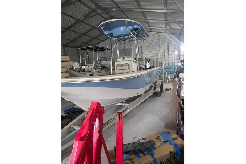 The Image of 2021 Carolina Skiff 26 Ultra Elite boat stored in a metal garage. - 0