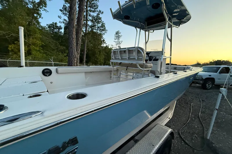 Slide: The Image of 2021 Carolina Skiff 26 Ultra Elite boat seats with Honda outboard motor in a storage area. - 13