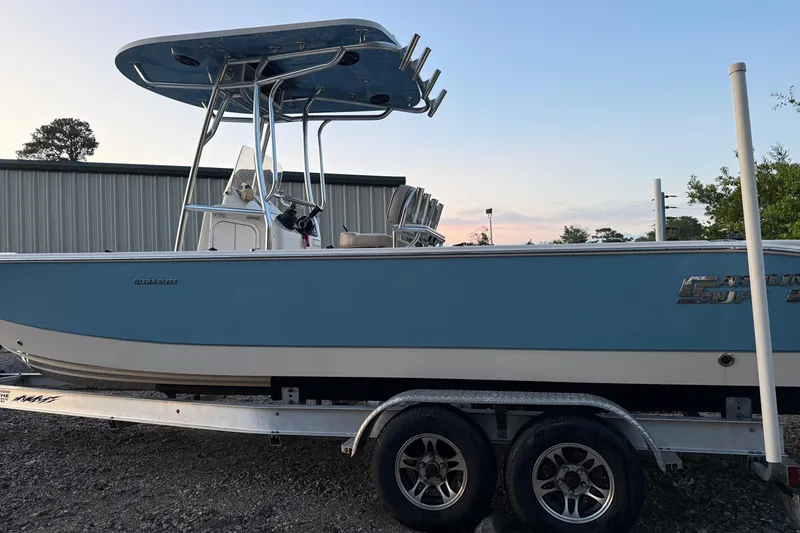 Slide: The Image of 2021 Carolina Skiff 26 Ultra Elite dashboard with steering wheel and navigation controls. - 16