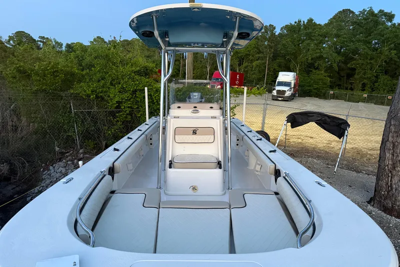 Slide: The Image of 2021 Carolina Skiff 26 Ultra Elite boat interior with cushioned seating and storage compartments. - 18