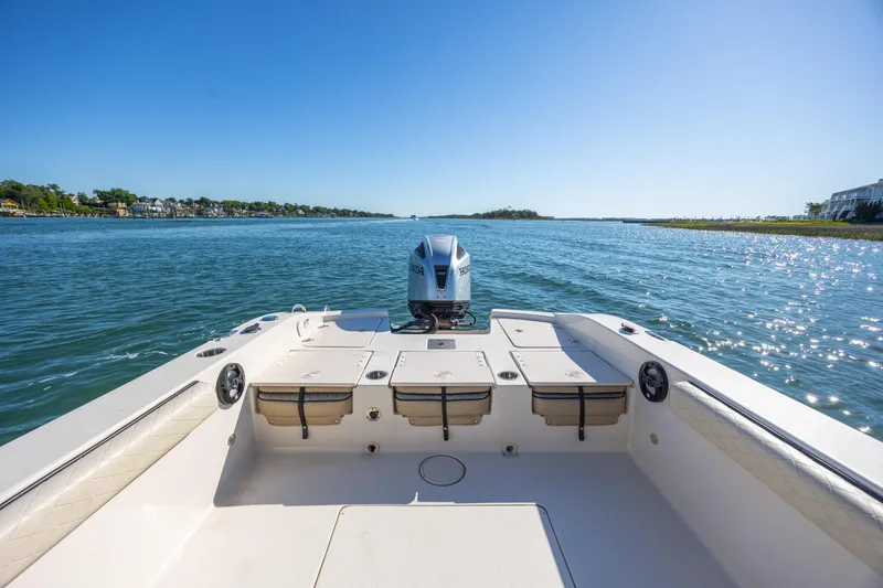 Slide: The Image of 2021 Carolina Skiff 26 Ultra Elite boat on serene water under clear blue sky. - 21