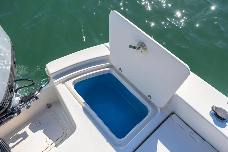 Slide: The Image of 2021 Carolina Skiff 26 Ultra Elite boat with open storage compartment on deck. - 22