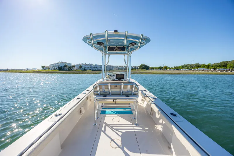 Slide: The Image of 2021 Carolina Skiff 26 Ultra Elite boat on calm water under clear blue sky. - 26