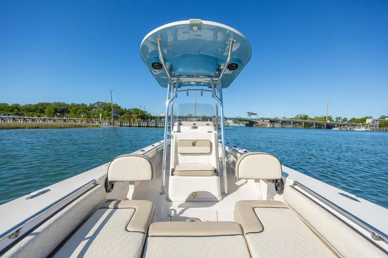 Slide: The Image of 2021 Carolina Skiff 26 Ultra Elite boat on calm water, featuring spacious seating and sleek design. - 27