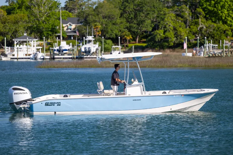 Slide: The Image of 2021 Carolina Skiff 26 Ultra Elite boat cruising on a calm lake. - 29