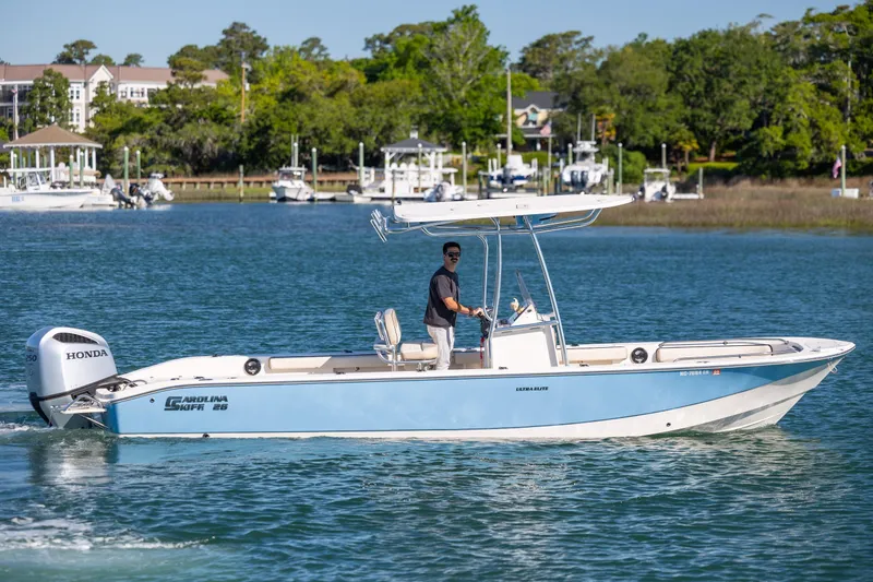 Slide: The Image of 2021 Carolina Skiff 26 Ultra Elite boat cruising on a scenic waterway. - 37