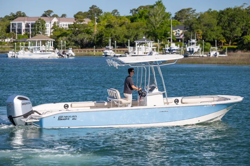 Slide: The Image of 2021 Carolina Skiff 26 Ultra Elite boat cruising on a scenic waterway. - 39