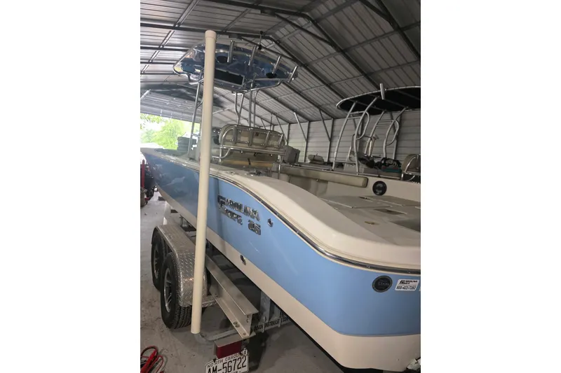 Slide: The Image of 2021 Carolina Skiff 26 Ultra Elite boat on trailer with Honda outboard motor. - 4