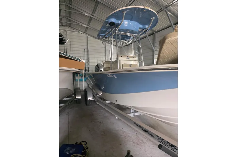 Slide: The Image of 2021 Carolina Skiff 26 Ultra Elite boat on trailer, parked near storage facility. - 5