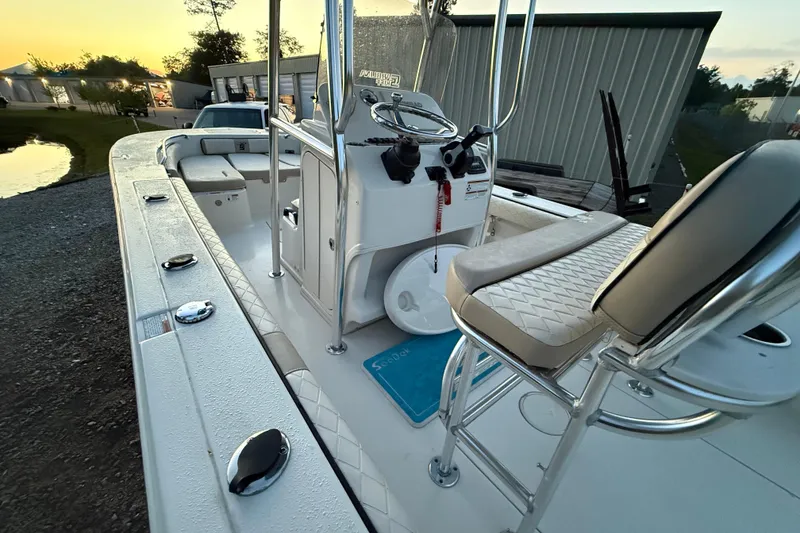 Slide: The Image of 2021 Carolina Skiff 26 Ultra Elite boat with blue hull and T-top. - 9