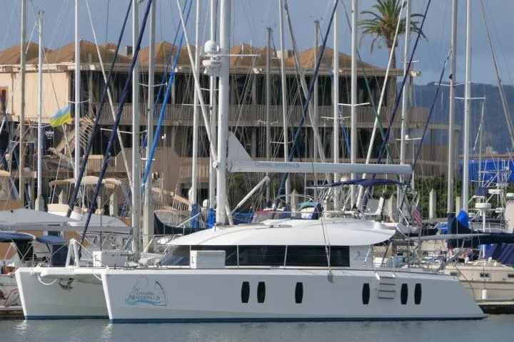 The Image of Sailing yacht Tayana Isara 50, 2014 model, docked in a marina with masts and buildings. - 1