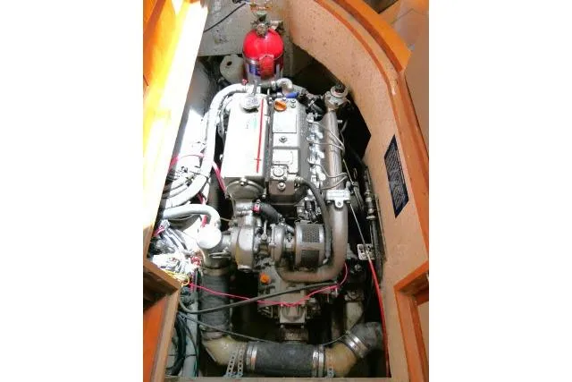 Slide: The Image of Engine compartment of 2014 Tayana Isara 50 yacht, featuring a well-maintained marine engine. - 100