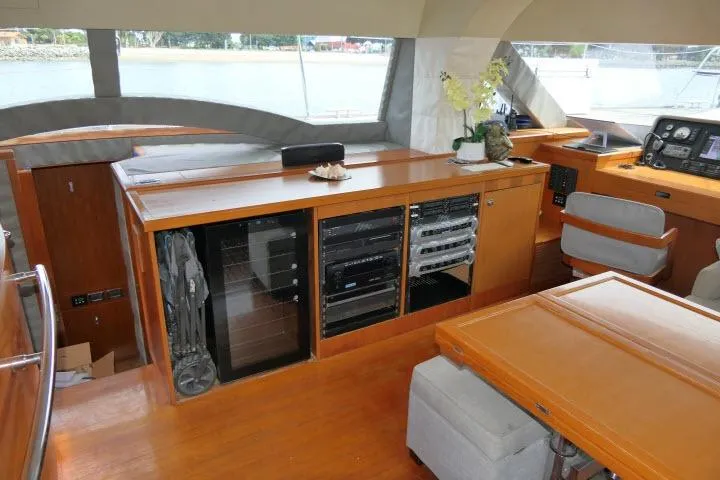 Slide: The Image of Interior of 2014 Tayana Isara 50 yacht with wooden cabinetry and modern navigation equipment. - 12