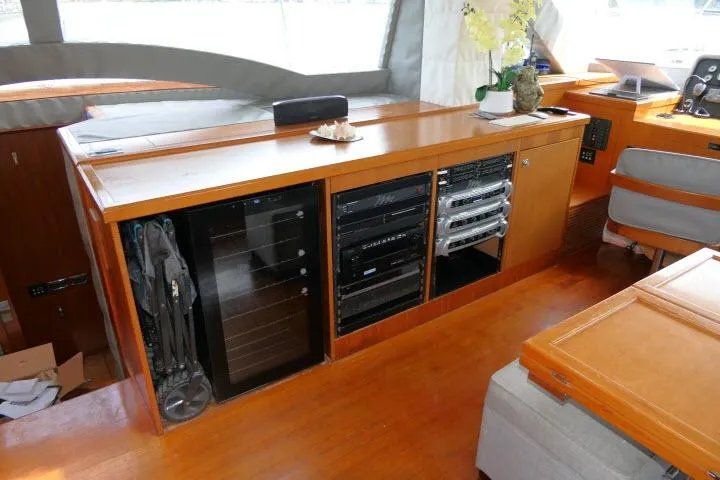 Slide: The Image of Interior of 2014 Tayana Isara 50 yacht with wooden cabinetry and electronic equipment. - 13