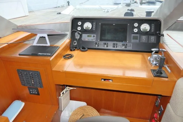 Slide: The Image of Control panel of a 2014 Tayana Isara 50 yacht, featuring navigation and communication equipment. - 16