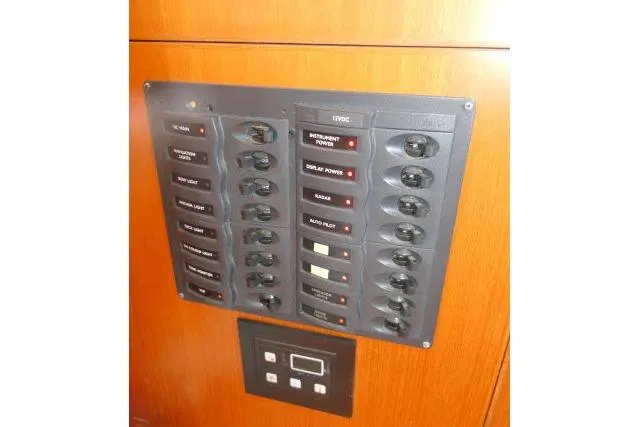 Slide: The Image of Electrical panel on 2014 Tayana Isara 50 yacht, featuring labeled switches and controls. - 17