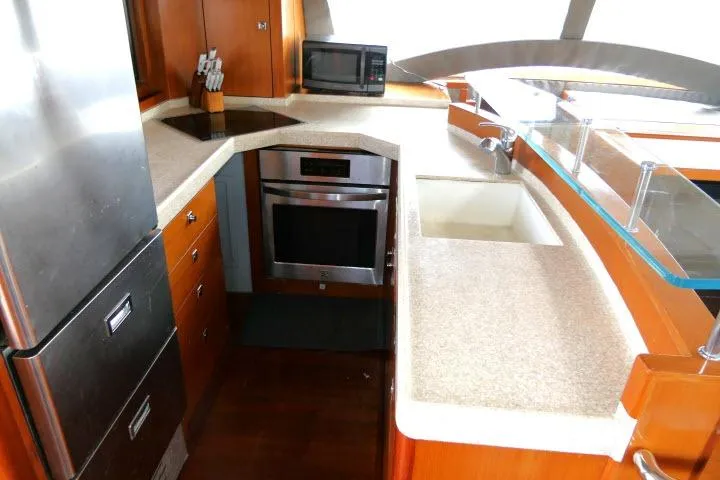 Slide: The Image of Modern kitchen in 2014 Tayana Isara 50 yacht with stainless steel appliances and wooden cabinetry. - 23