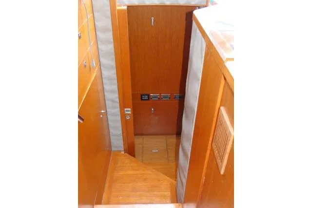 Slide: The Image of Interior view of 2014 Tayana Isara 50 yacht, featuring wooden stairs and cabinetry. - 26