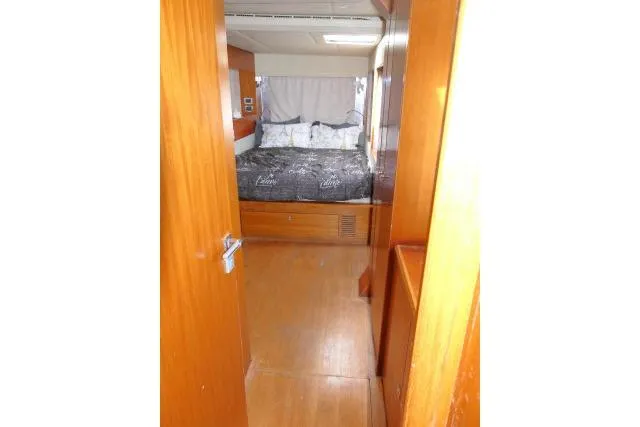 Slide: The Image of Interior cabin view of 2014 Tayana Isara 50 yacht with wooden finish and cozy bed. - 28