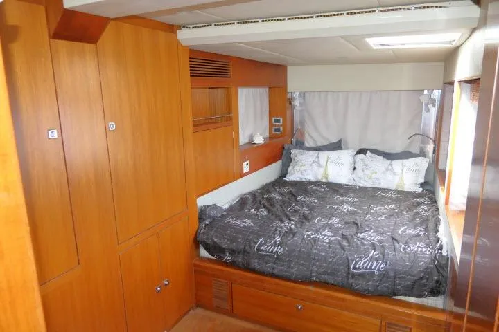 Slide: The Image of Luxurious bedroom interior of 2014 Tayana Isara 50 yacht with cozy bedding and wooden cabinetry. - 30