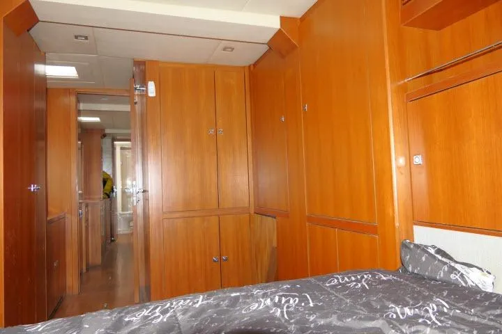 Slide: The Image of Interior of 2014 Tayana Isara 50 yacht with wooden cabinetry and cozy bedding. - 34