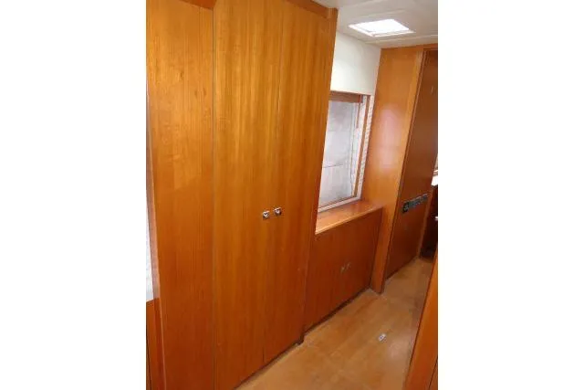 Slide: The Image of Interior view of 2014 Tayana Isara 50 yacht with wooden cabinetry and window. - 35