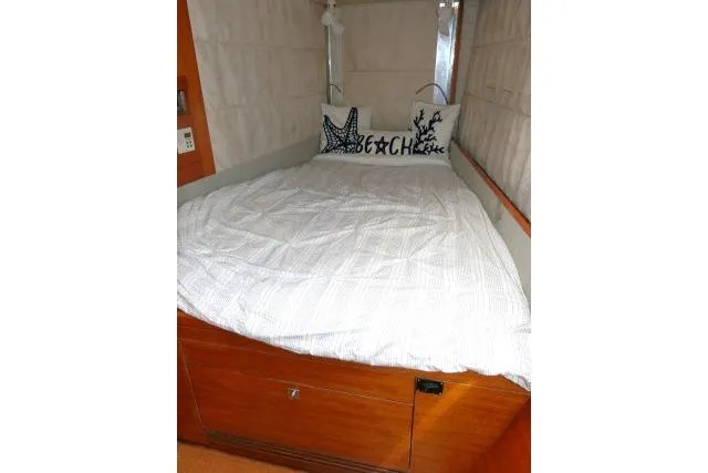 Slide: The Image of Cozy cabin bed in 2014 Tayana Isara 50 yacht with nautical-themed pillows. - 44