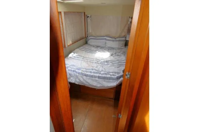 Slide: The Image of Cozy bedroom interior of 2014 Tayana Isara 50 yacht with striped bedding. - 50