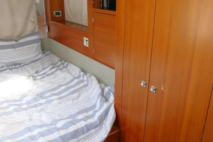 Slide: The Image of Cozy cabin interior of 2014 Tayana Isara 50 yacht with striped bedding and wooden cabinetry. - 52