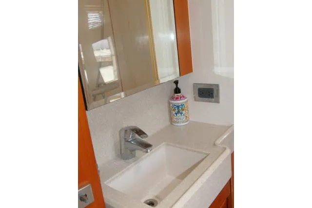 Slide: The Image of Bathroom sink area on 2014 Tayana Isara 50 yacht with mirror and soap dispenser. - 56