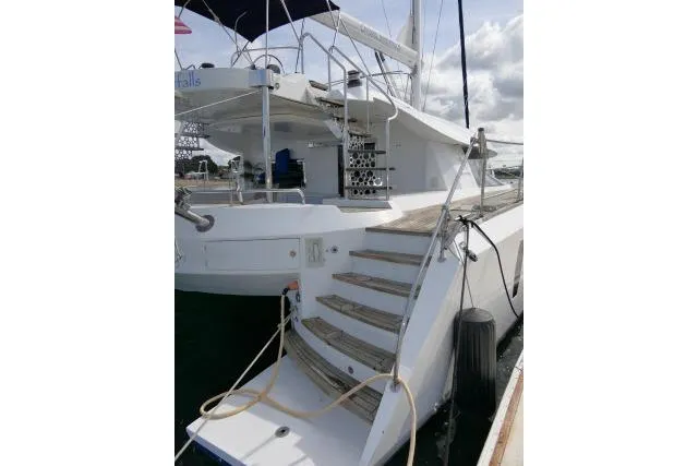 Slide: The Image of 2014 Tayana Isara 50 yacht with wooden steps and sleek design at the dock. - 58
