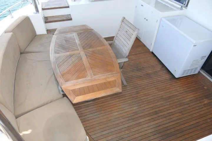 Slide: The Image of Cozy deck seating on 2014 Tayana Isara 50 yacht with wooden table and chair. - 65