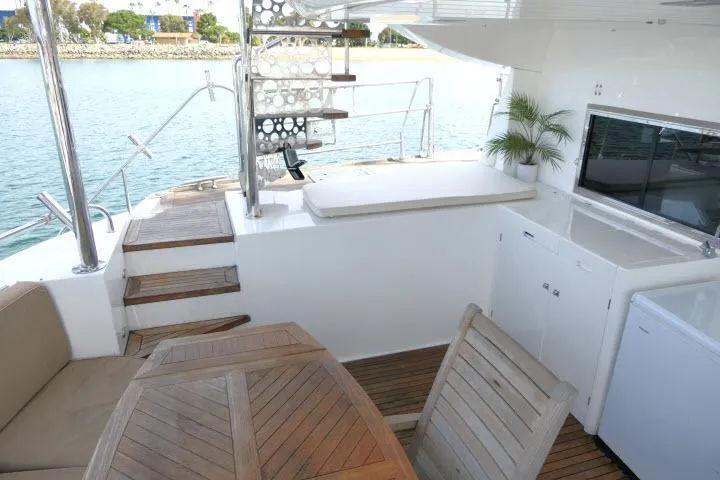 Slide: The Image of Luxurious 2014 Tayana Isara 50 yacht deck with seating, table, and ocean view. - 66