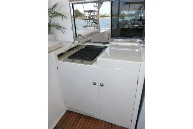 Slide: The Image of Outdoor grill area on 2014 Tayana Isara 50 yacht with sleek white cabinetry. - 69