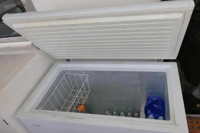 Slide: The Image of Open freezer on Tayana Isara 50 yacht, containing bottles and a basket, 2014 model. - 71