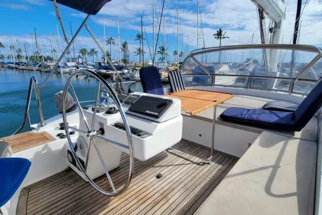 Slide: The Image of Cockpit of 2014 Tayana Isara 50 yacht with steering wheel and seating in marina. - 74