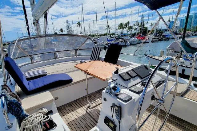 Slide: The Image of Cockpit of 2014 Tayana Isara 50 yacht with seating, table, and marina view. - 75