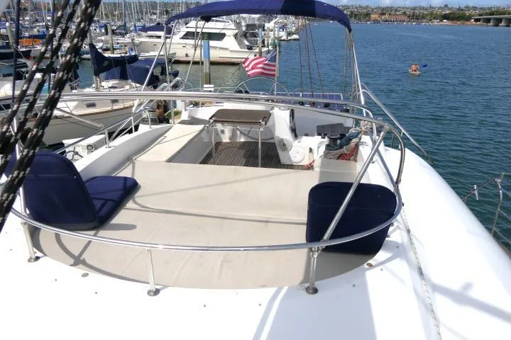 Slide: The Image of 2014 Tayana Isara 50 yacht with spacious deck, docked in a marina. - 79
