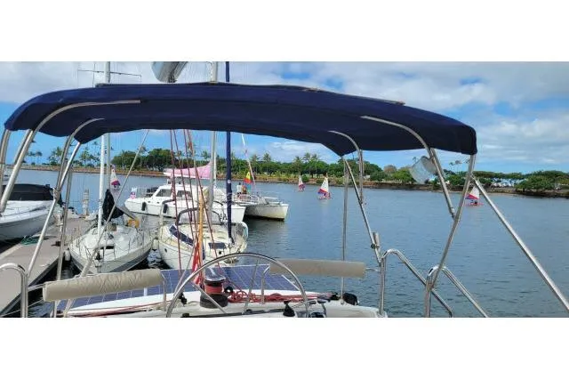 Slide: The Image of Sailboats docked at a marina, featuring a 2014 Tayana Isara 50 under a blue sky. - 80