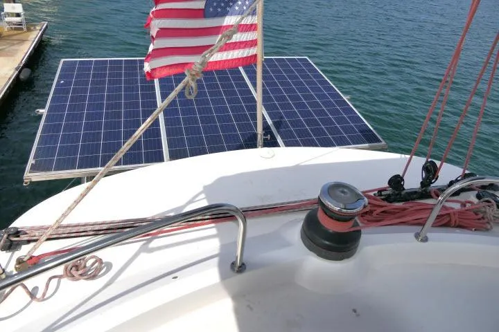 Slide: The Image of Sailboat Tayana Isara 50 with solar panels and American flag, docked in 2014. - 81