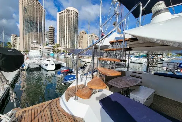 Slide: The Image of Luxurious 2014 Tayana Isara 50 yacht docked in a marina with city skyline. - 82