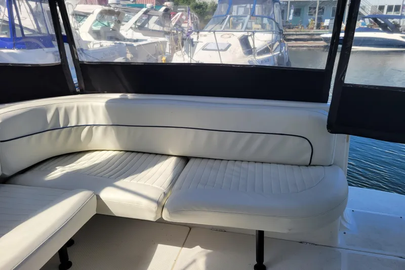 Slide: The Image of Interior seating of 1999 Bayliner 3055 Ciera Sunbridge boat at marina. - 10
