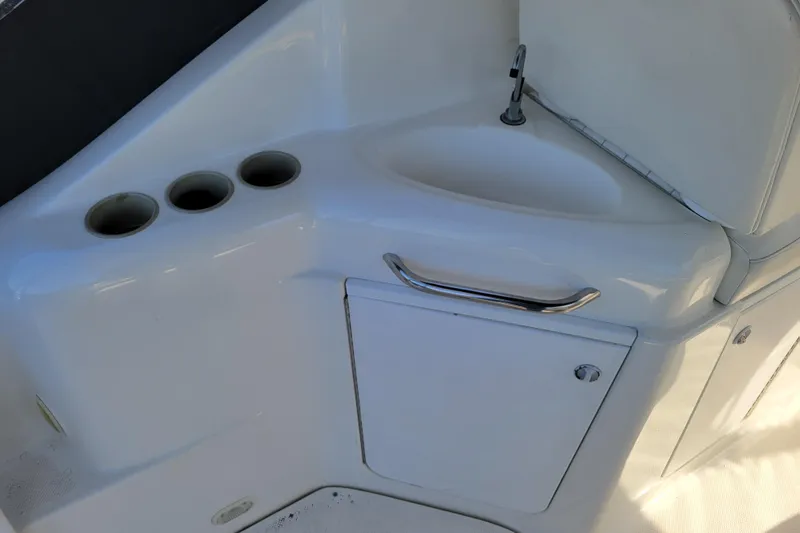 Slide: The Image of 1999 Bayliner 3055 Ciera Sunbridge boat sink and storage area. - 11