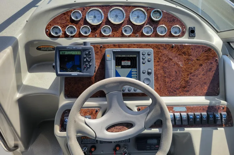 Slide: The Image of 1999 Bayliner 3055 Ciera Sunbridge dashboard with GPS and navigation controls. - 14