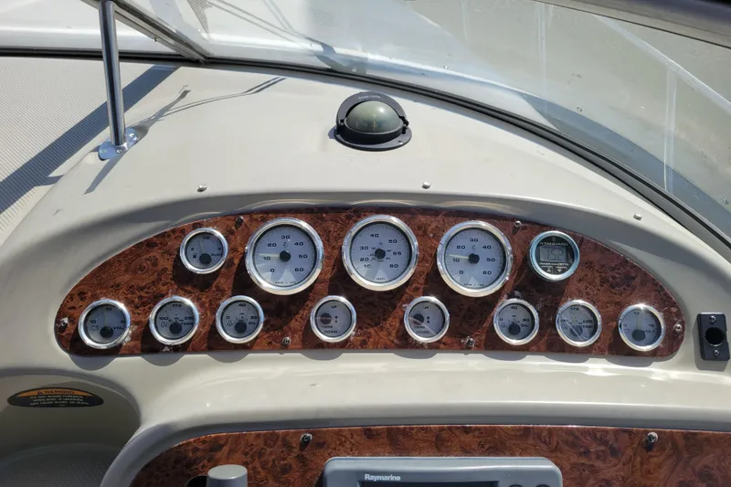 Slide: The Image of Dashboard of a 1999 Bayliner 3055 Ciera Sunbridge with gauges and compass. - 15