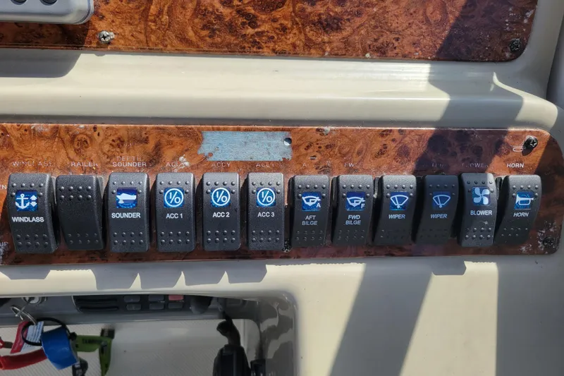 Slide: The Image of Control panel of a 1999 Bayliner 3055 Ciera Sunbridge with labeled switches. - 18