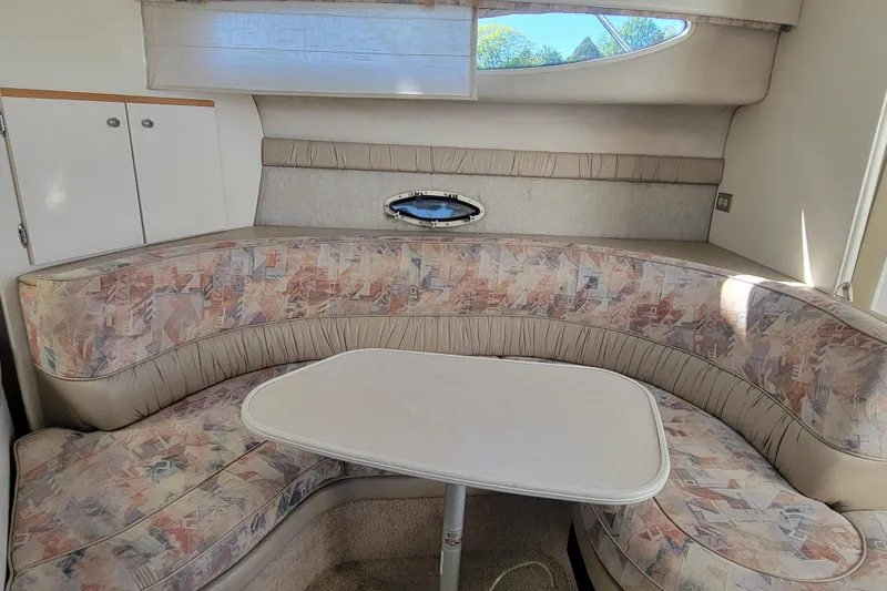 Slide: The Image of Interior of 1999 Bayliner 3055 Ciera Sunbridge with patterned seating and table. - 21