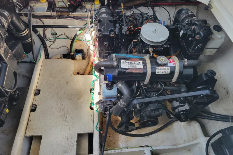 Slide: The Image of Engine compartment of a 1999 Bayliner 3055 Ciera Sunbridge boat, showing detailed components. - 27