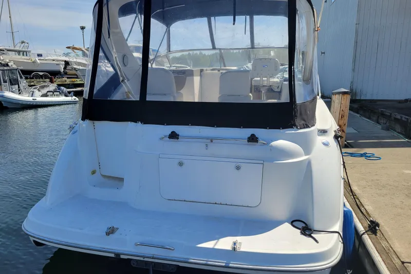 Slide: The Image of 1999 Bayliner 3055 Ciera Sunbridge docked at marina, rear view. - 4