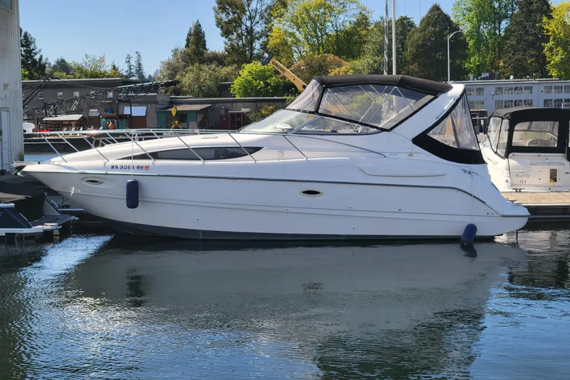Slide: The Image of 1999 Bayliner 3055 Ciera Sunbridge boat docked in a marina, side view. - 6